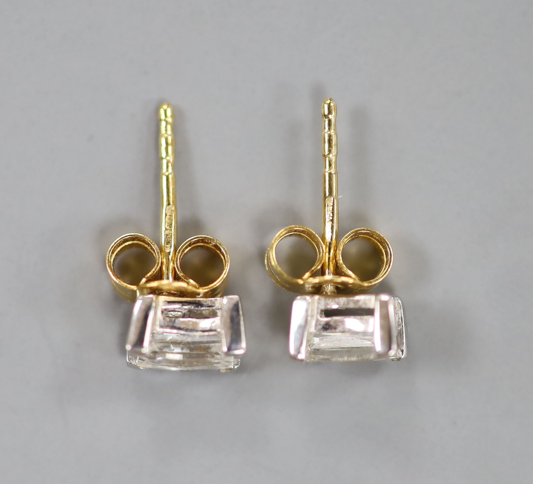 A pair of millennium cut diamond and gold stud earrings.